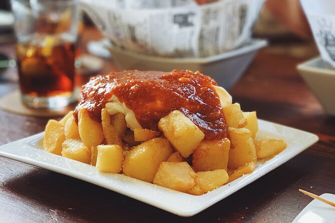 Barcelona Food Tour: Tapas, Drinks and Delights with a Local - Carrer del Regomir: pan con tomate, pimientos del padron, and cava