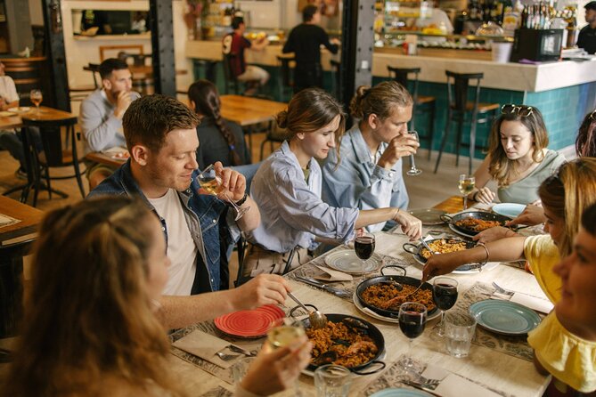 Barcelona: Guided Food Walking Tour with Tapas and Wine - Old neighborhoods on foot: Carrer de la Viladecols and the Roman walls vibe