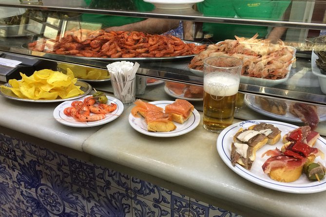 Barcelona Morning Tapas Crawl by Food Tour - Starting at Pl. de Catalunya, then walking into the old lanes