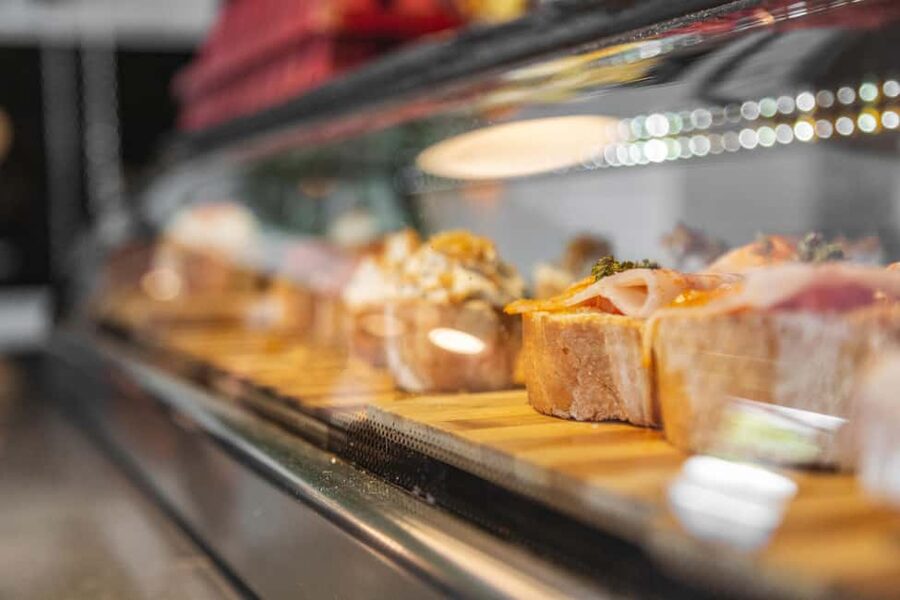 Madrid: Guided Food Tour with Authentic Tapas & Delicacies - Stop by Stop: Squid Sandwiches, Tortilla, Bravas, and More