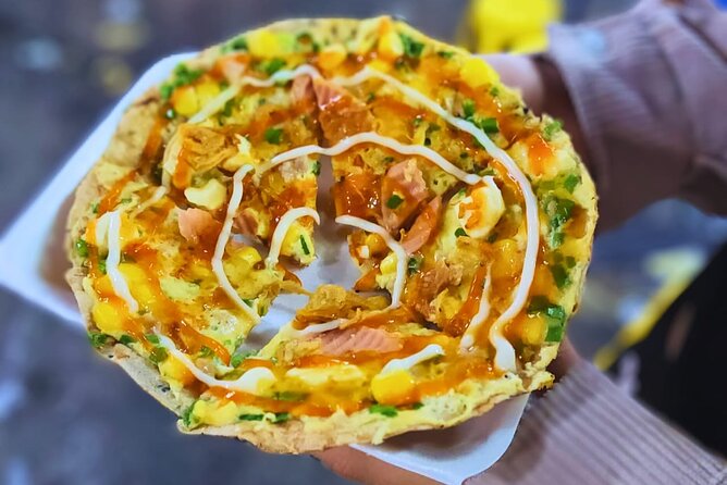 Saigon Food Tour by Scooter with Eleven Tastings - District 10 street food walk: herbs, bao buns, and crispy pork rice