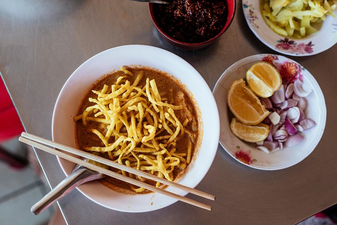 The 10 Tastings of Chiang Mai With Locals: Private Street Food Tour - Stop 3: Chang Phuak Gate (Elephant Gate) and a Local Restaurant Bite