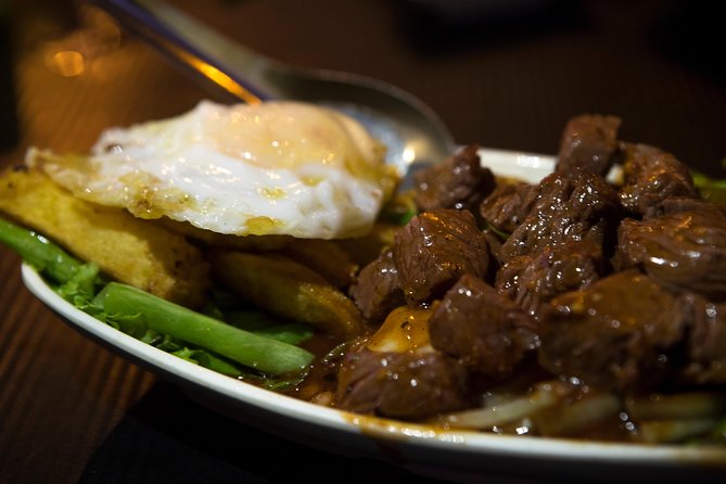 Ultimate Phnom Penh Food Tour by Tuk Tuk: 20 Tastings and Drinks - Stop 1: Royal Palace back-alley bite with multi-generation cooks