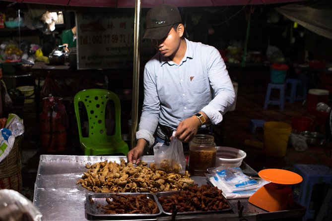 Ultimate Phnom Penh Food Tour by Tuk Tuk: 20 Tastings and Drinks - Stop 4: Russian Market at night for smoky, sticky pork ribs